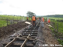 The track gang prepare sleepers up to the first occupation crossing