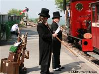 Travelling gentlemen see off the train from Woody Bay
